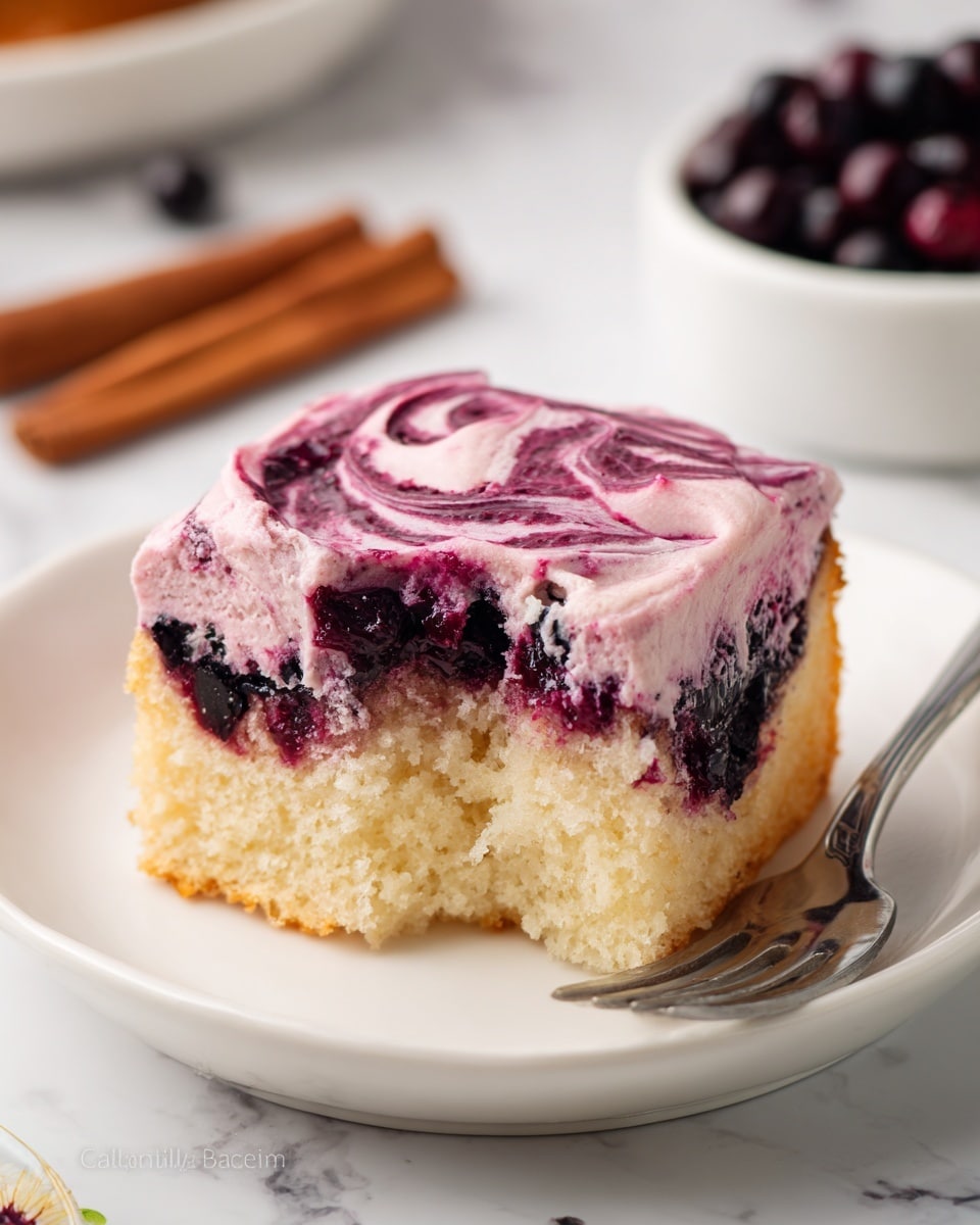A square piece of soft, light yellow cake with a dark purple jelly-like layer at the bottom sits on a white plate. On top, there is a smooth, thick layer of pink frosting with swirls of dark purple berry sauce mixed in, creating a marbled effect. The cake looks fluffy and moist, with a slightly torn edge revealing its airy texture. The plate is placed on a white marbled surface with two cinnamon sticks nearby and a silver fork resting beside the plate. In the background, there is a small white bowl filled with whole dark berries. Photo taken with an iphone --ar 4:5 --v 7