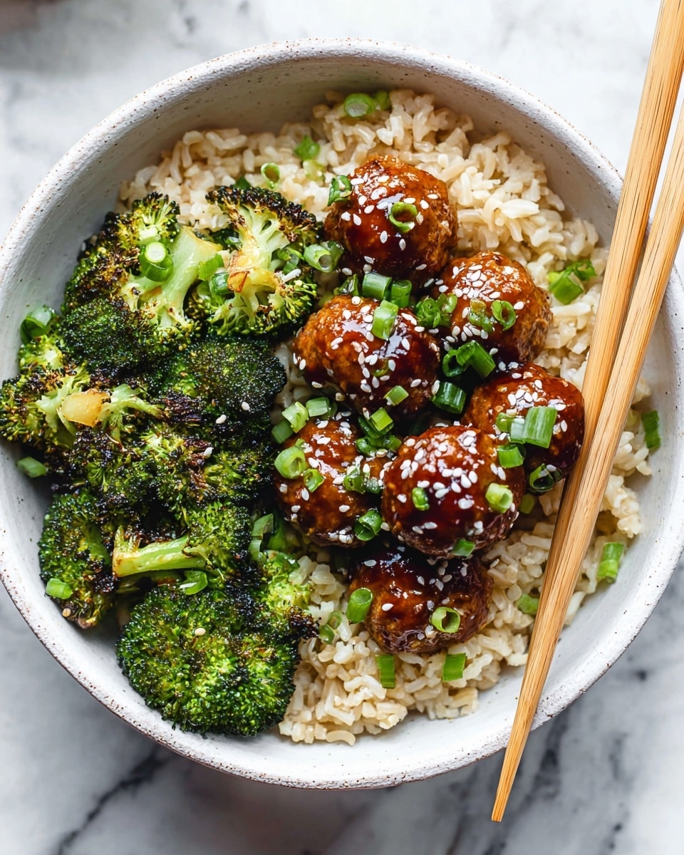 A white bowl filled with a base layer of light brown cooked rice, topped with bright green roasted broccoli florets on one side, showing some charred edges for texture, and on the other side, round glazed meatballs covered with a shiny, dark brown sauce sprinkled with white sesame seeds and chopped green onions. The bowl sits on a white marbled surface, and a pair of light brown wooden chopsticks rests inside the bowl as if ready to pick up the food. photo taken with an iphone --ar 4:5 --v 7